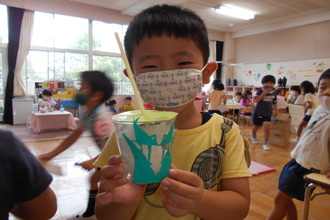 写真:切り絵の工作品を見せる年長さん