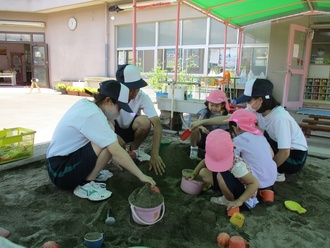 高校生と遊ぶ園児の写真1