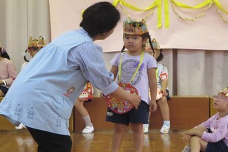 園長先生にプレゼントをもらう園児