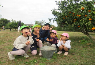 みかんを食べる嬉しそうな子どもたち