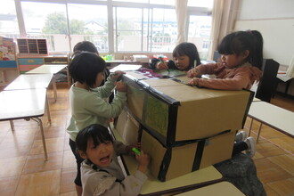 劇で使う大道具を使っている年長児